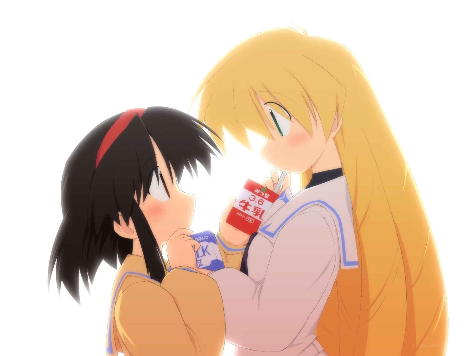 two girls sharing milk