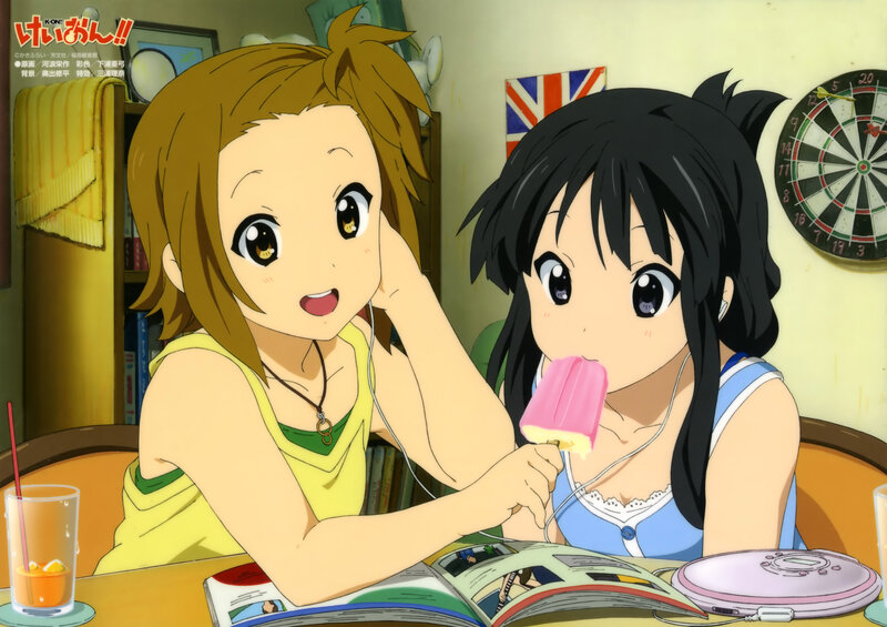 Two girls sharing music and a popsicle