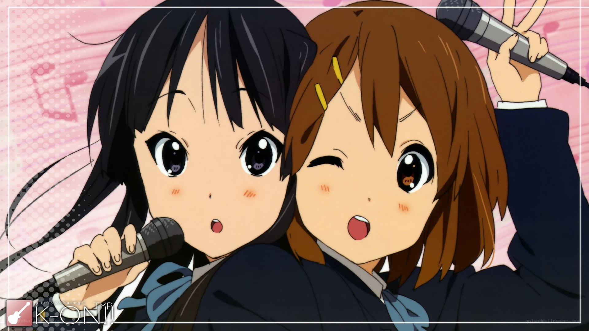 Two girls singing into microphones