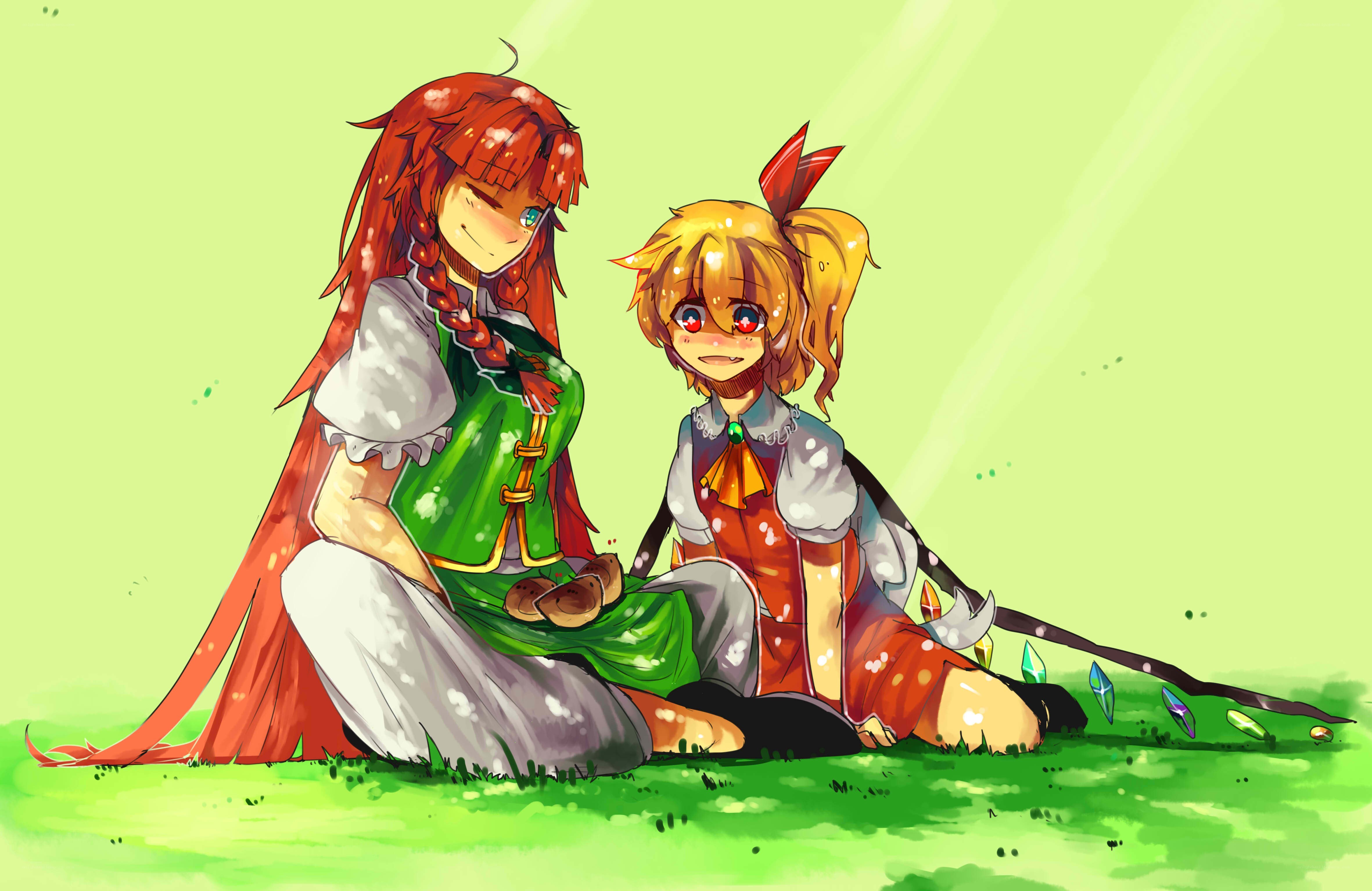 Two girls sitting on grass