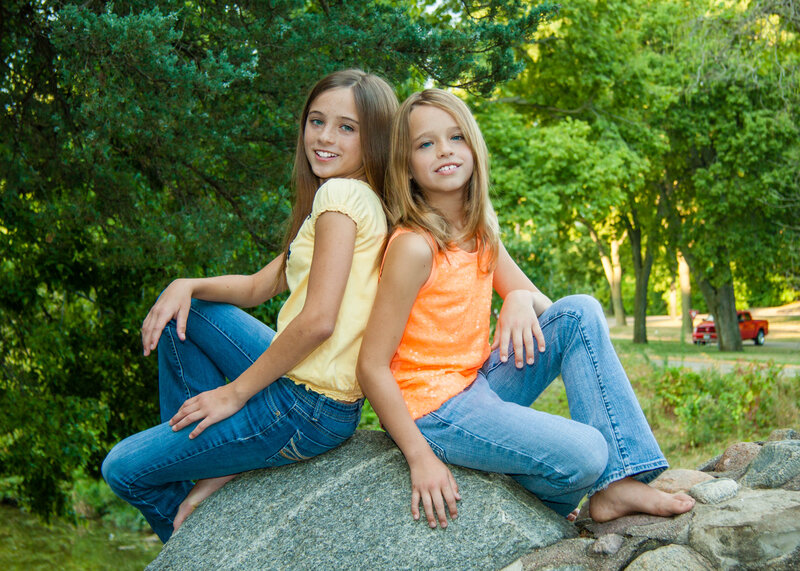 Two Girls Sitting on Rock