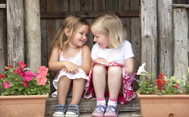 Two Girls Sitting — White, Peaceful