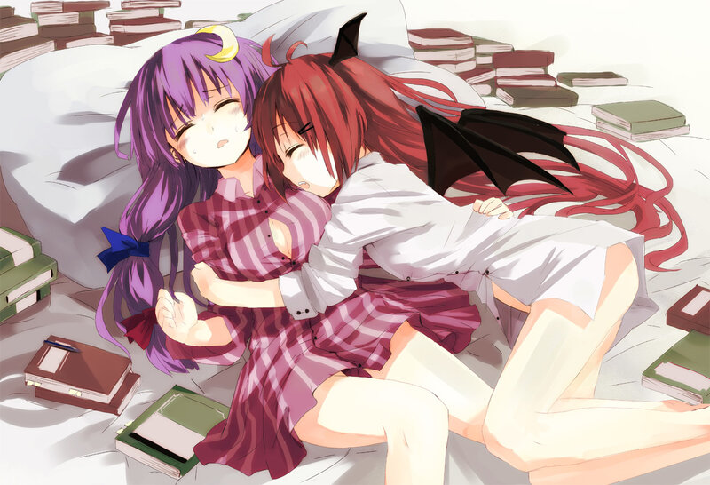 Two girls sleeping among books