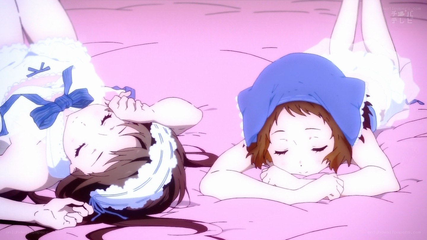 Two girls sleeping on a bed