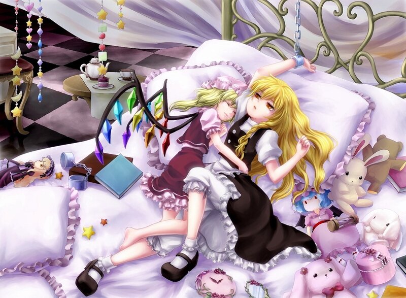 Two girls sleeping on a bed