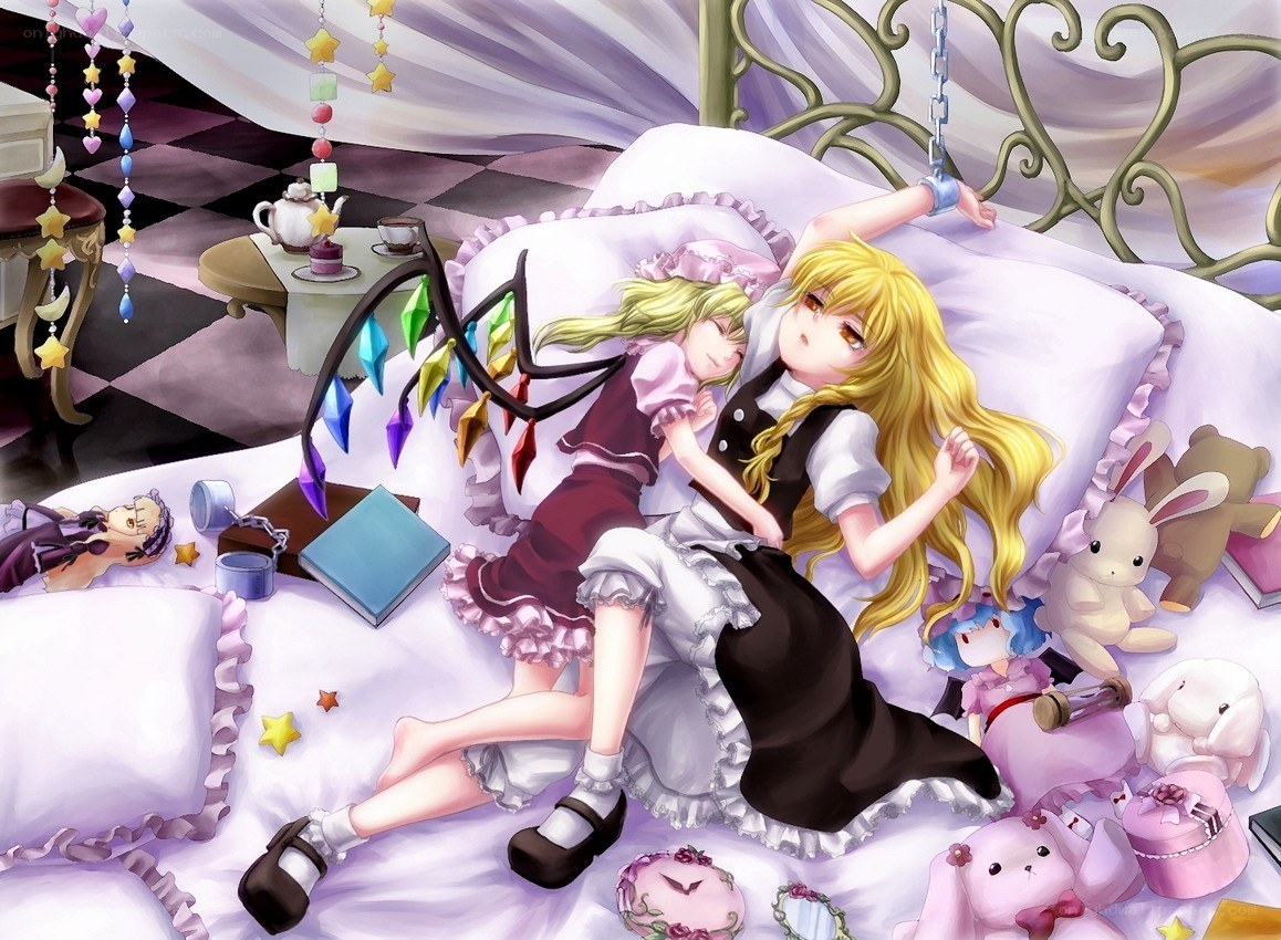 Two girls sleeping on a bed