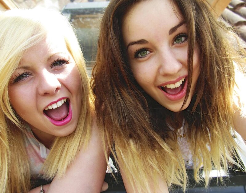 two girls smiling at camera