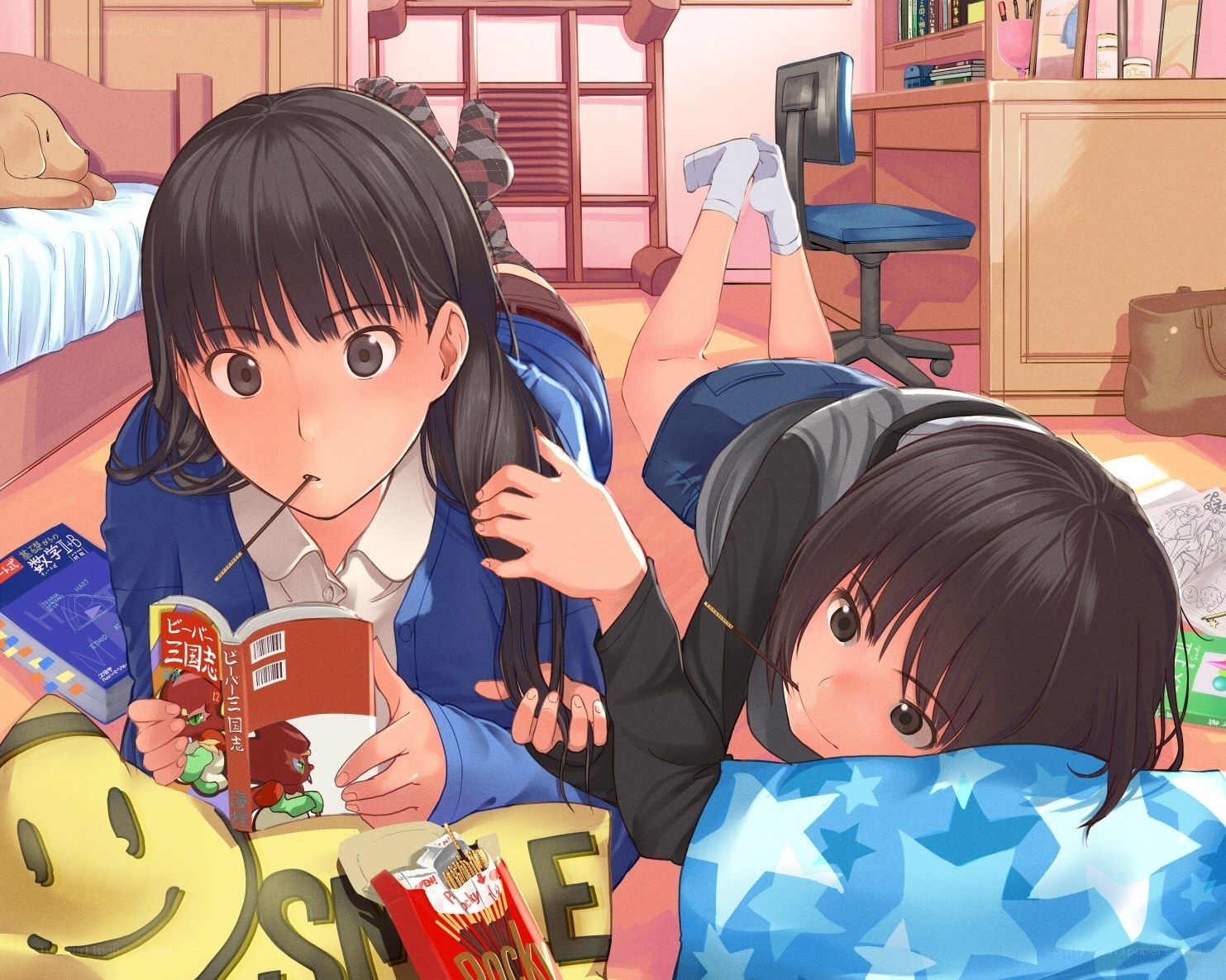 Two girls studying in a bedroom