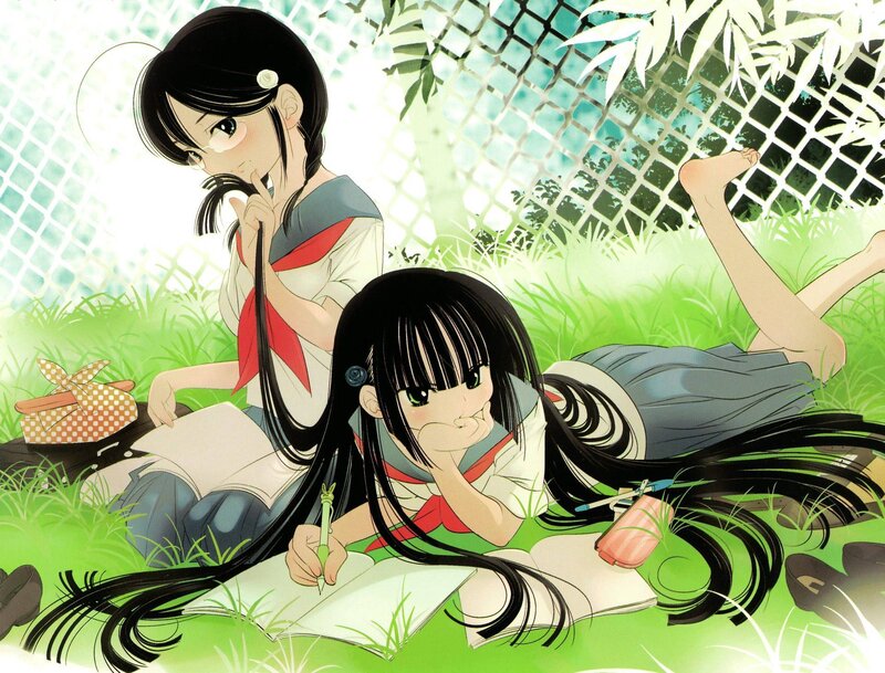 Two girls studying in the grass