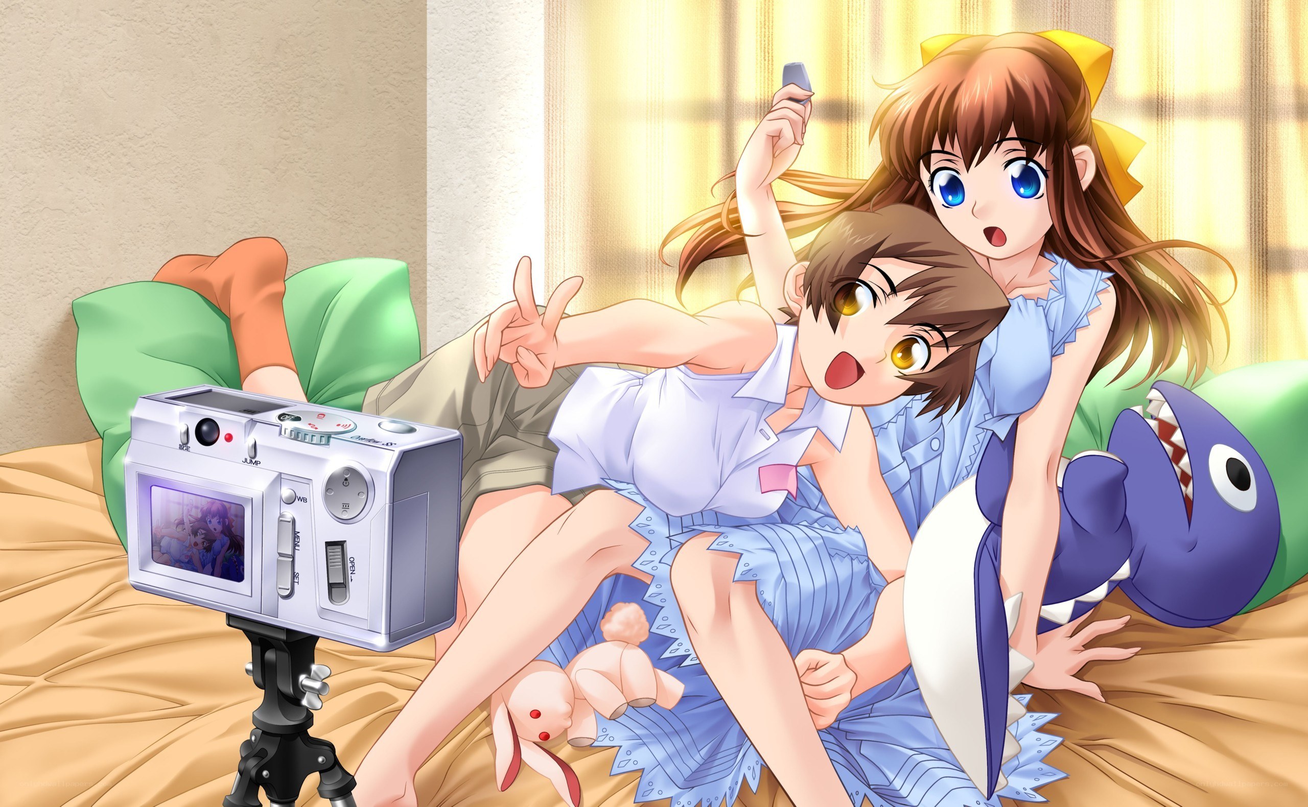 Two girls taking a selfie on bed