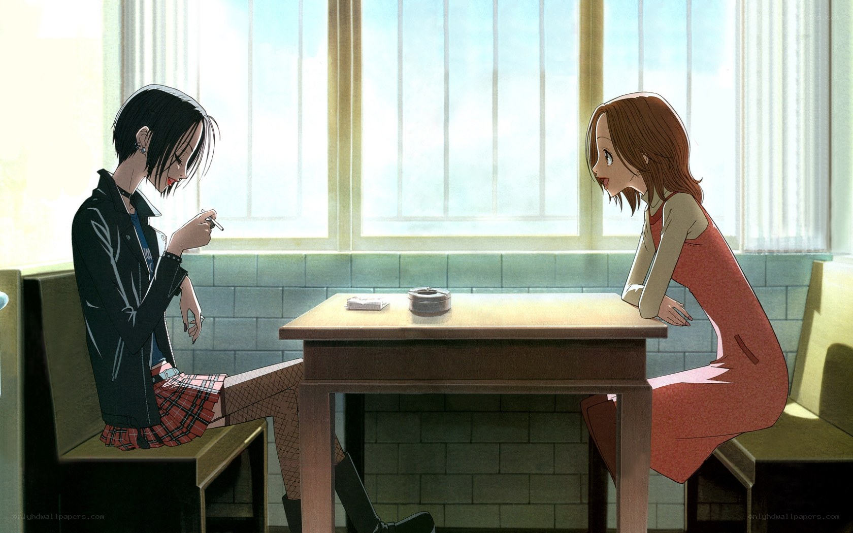 Two girls talking at a table