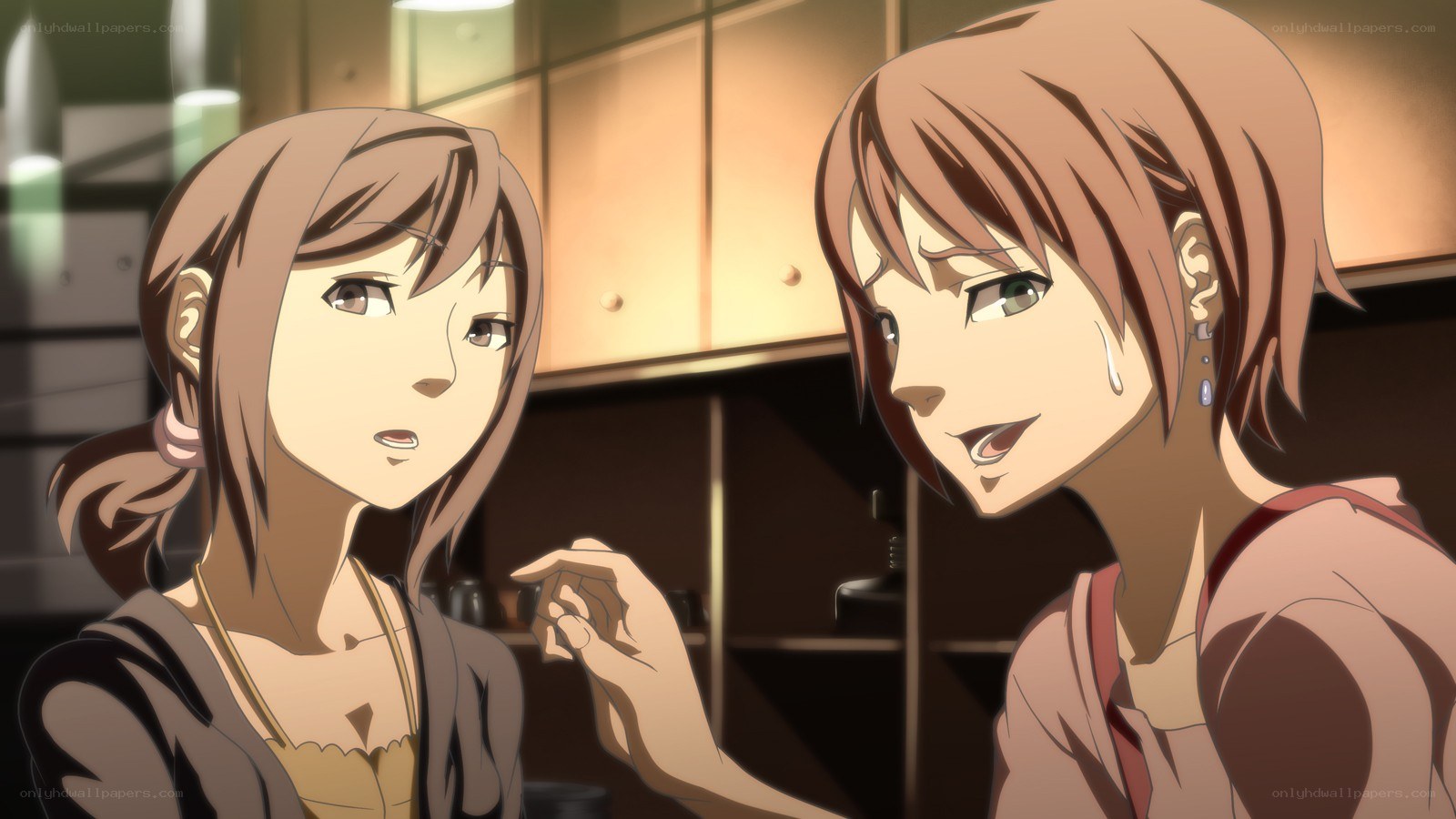 Two girls talking in a kitchen