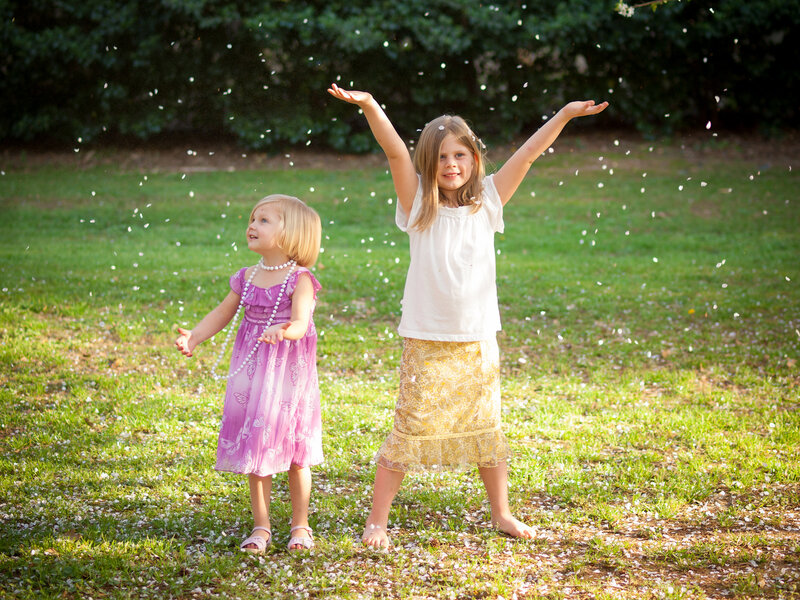 Two Girls Throwing Petals