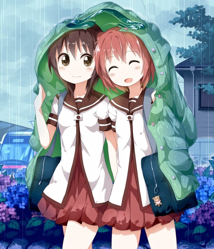 Two girls under a raincoat