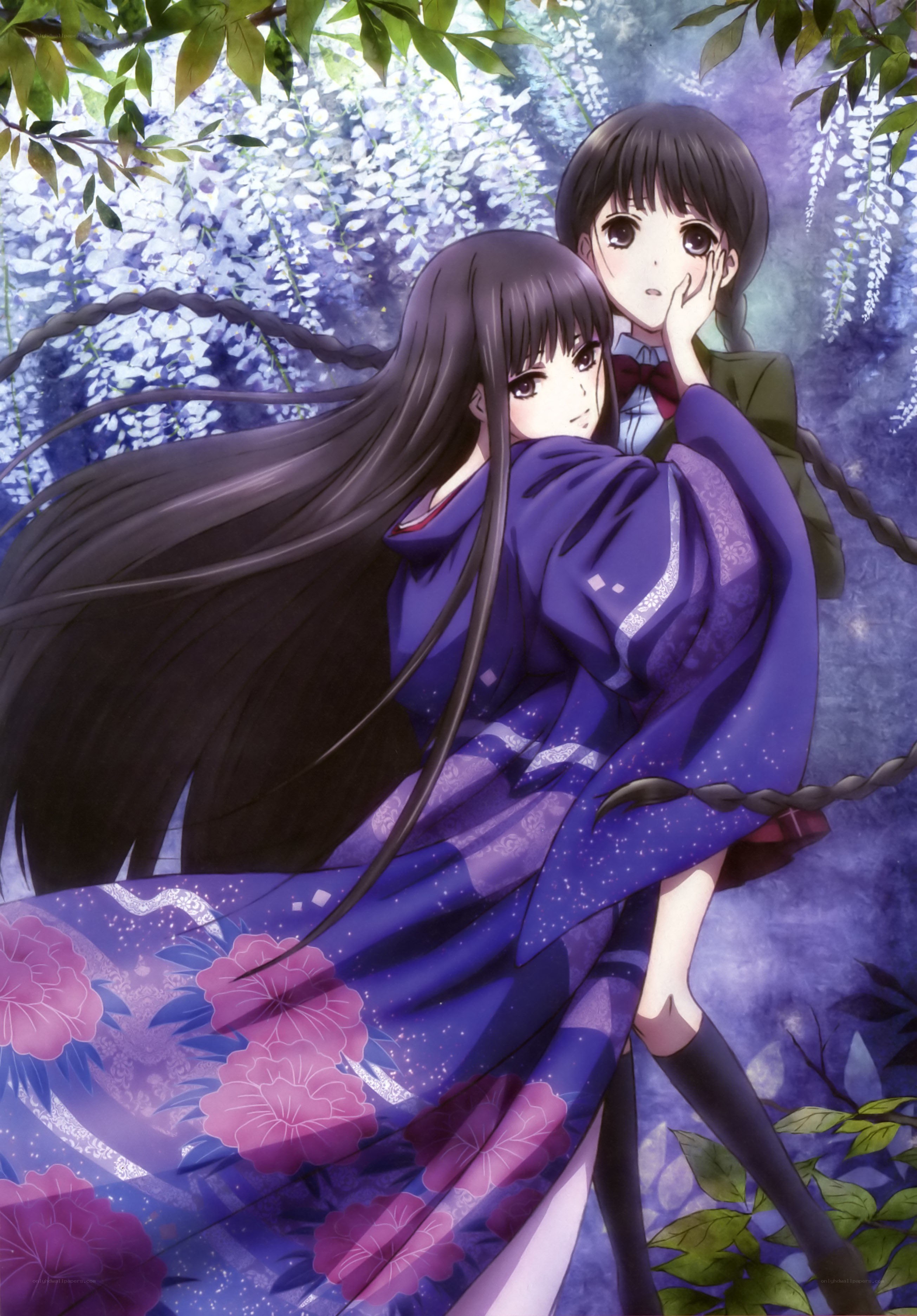 Two girls under wisteria blossoms