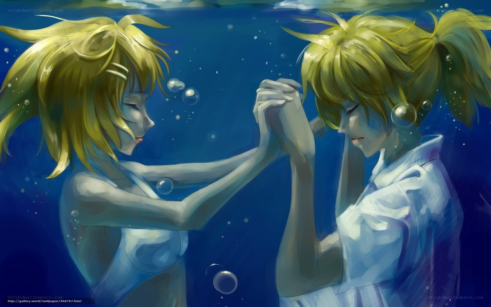 Two girls underwater holding hands