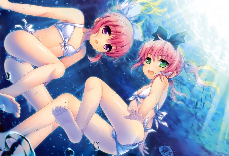 Two girls underwater in bikinis