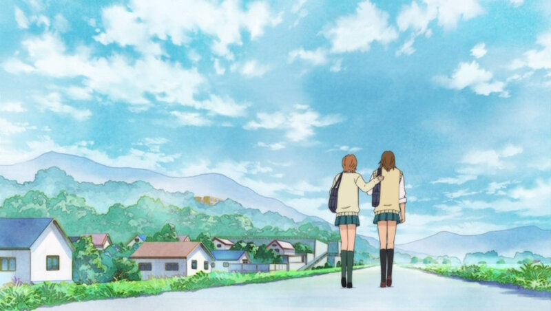 two girls walking on a road