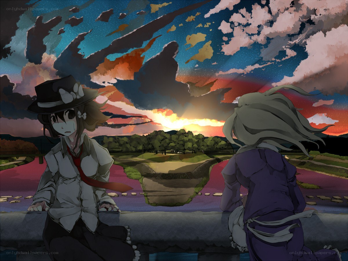 Two girls watch the sunset