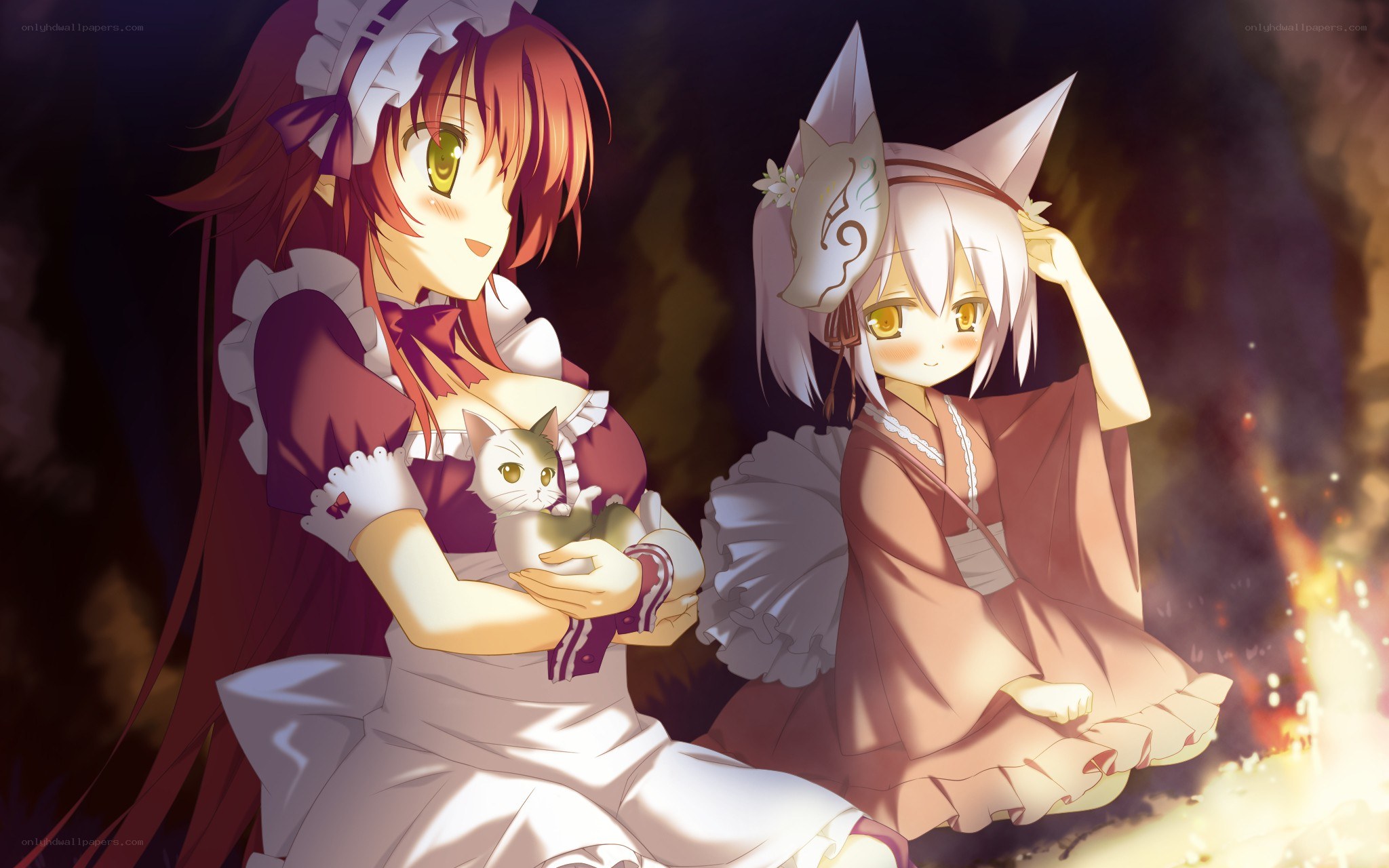 Two girls with a cat by firelight