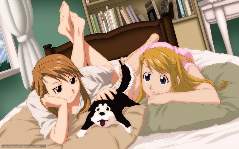 Two girls with a puppy in bed
