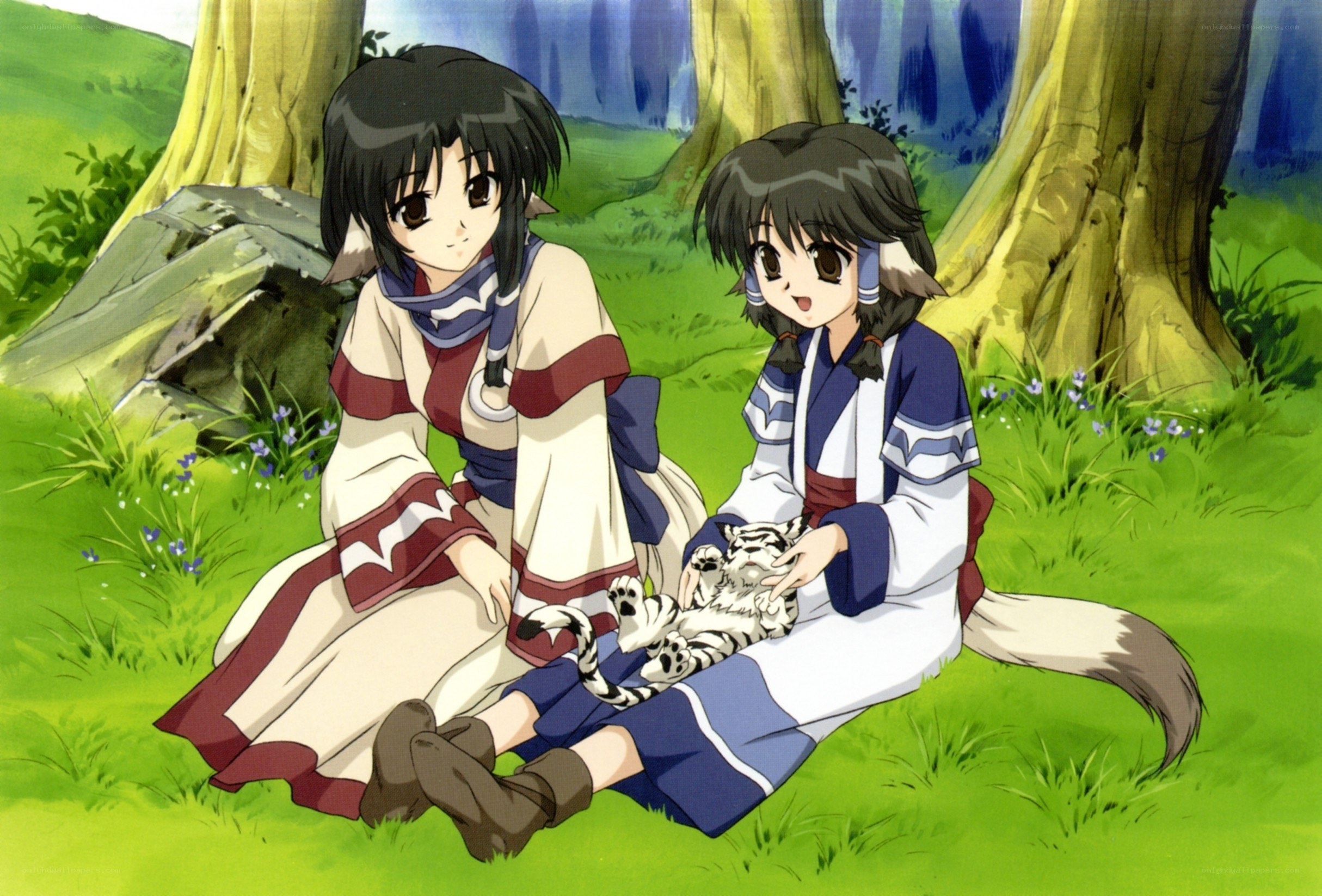 Two girls with a tiger cub