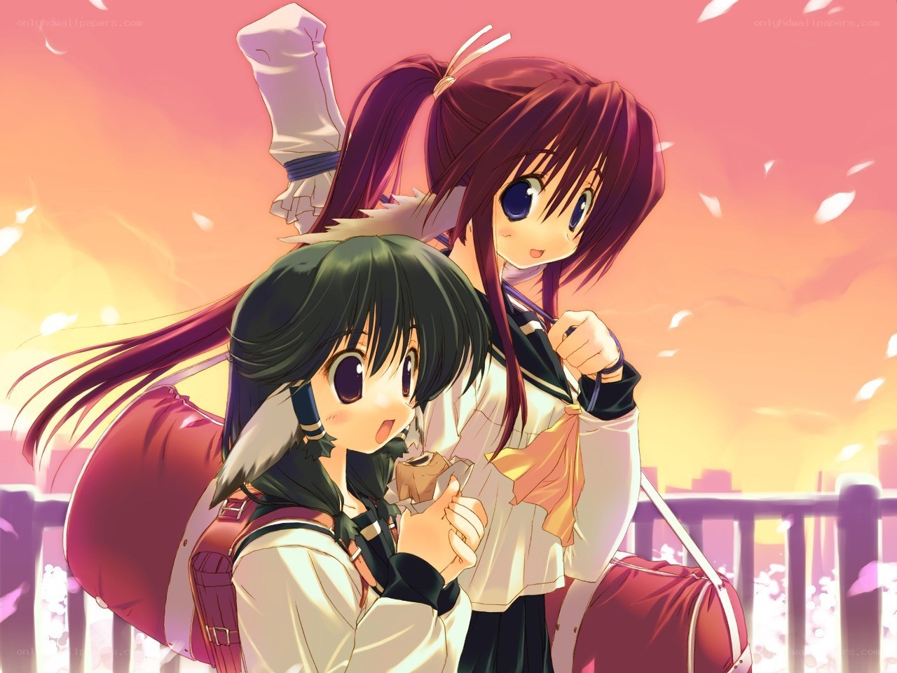Two girls with backpacks at sunset