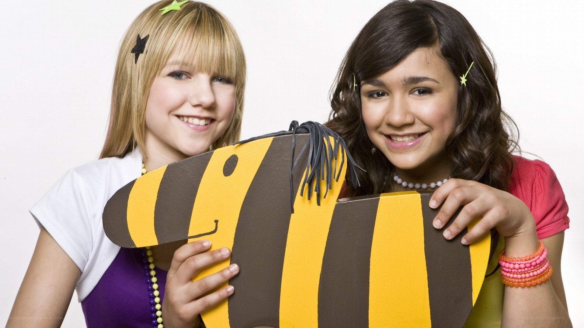 two girls with bee prop