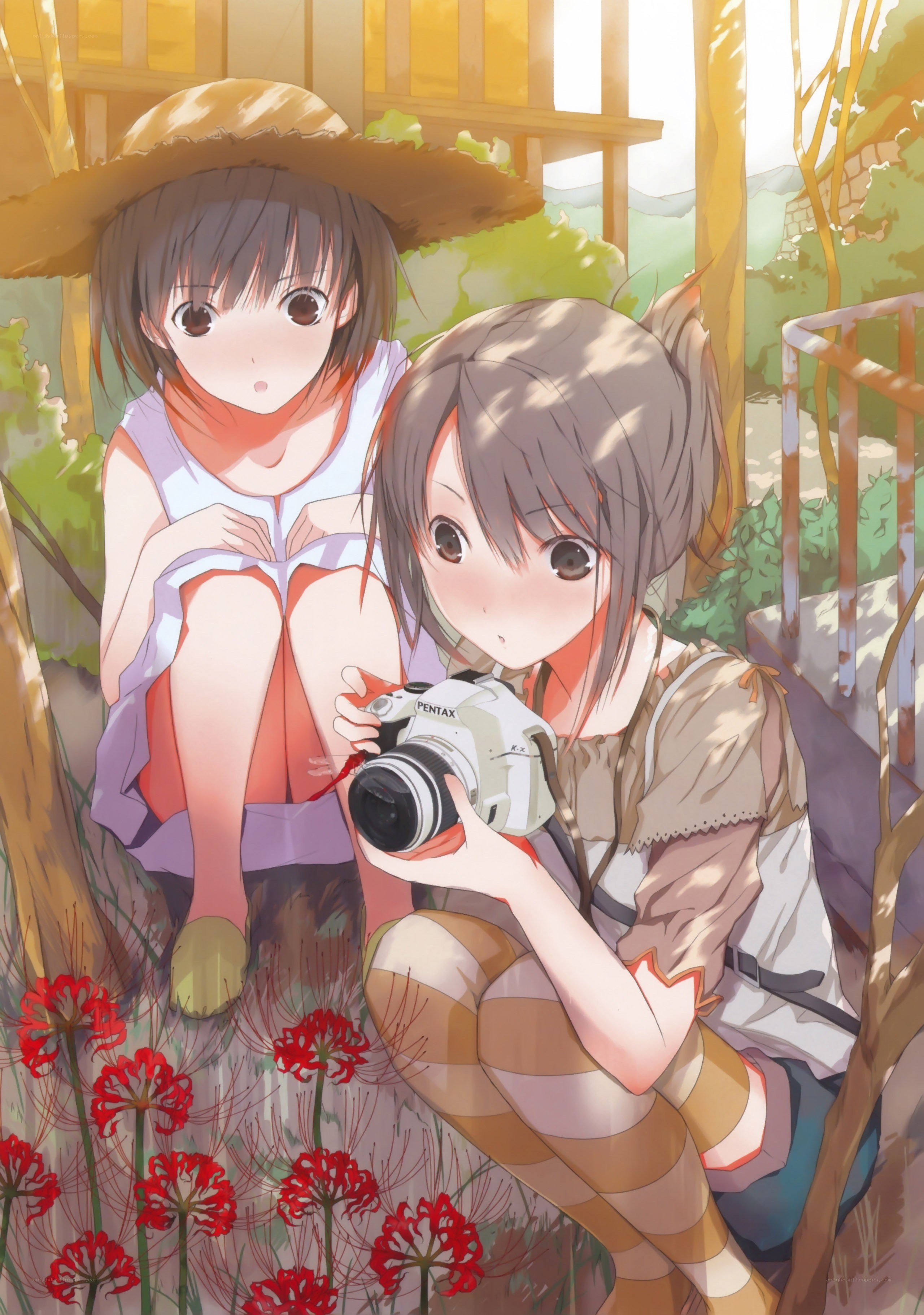 Two girls with camera in garden