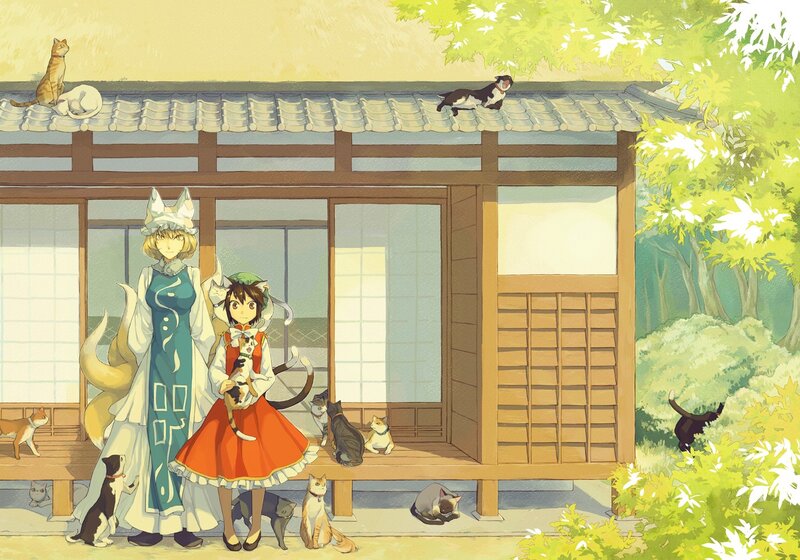 Two girls with cats in a garden