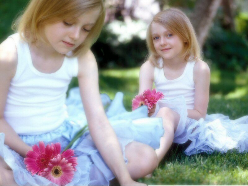 Two girls with flowers in a garden