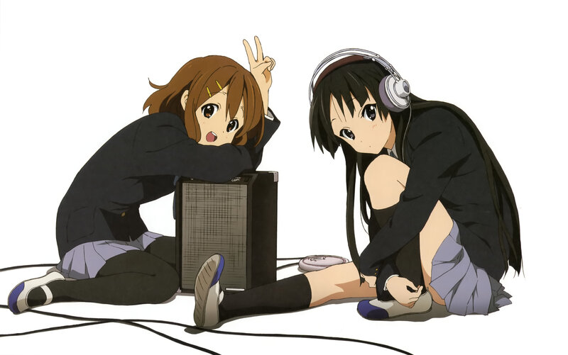 Two girls with headphones and speaker