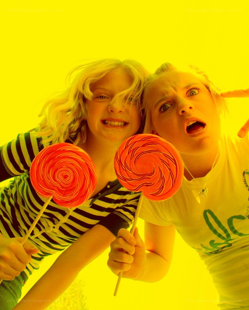 Two girls with lollipops