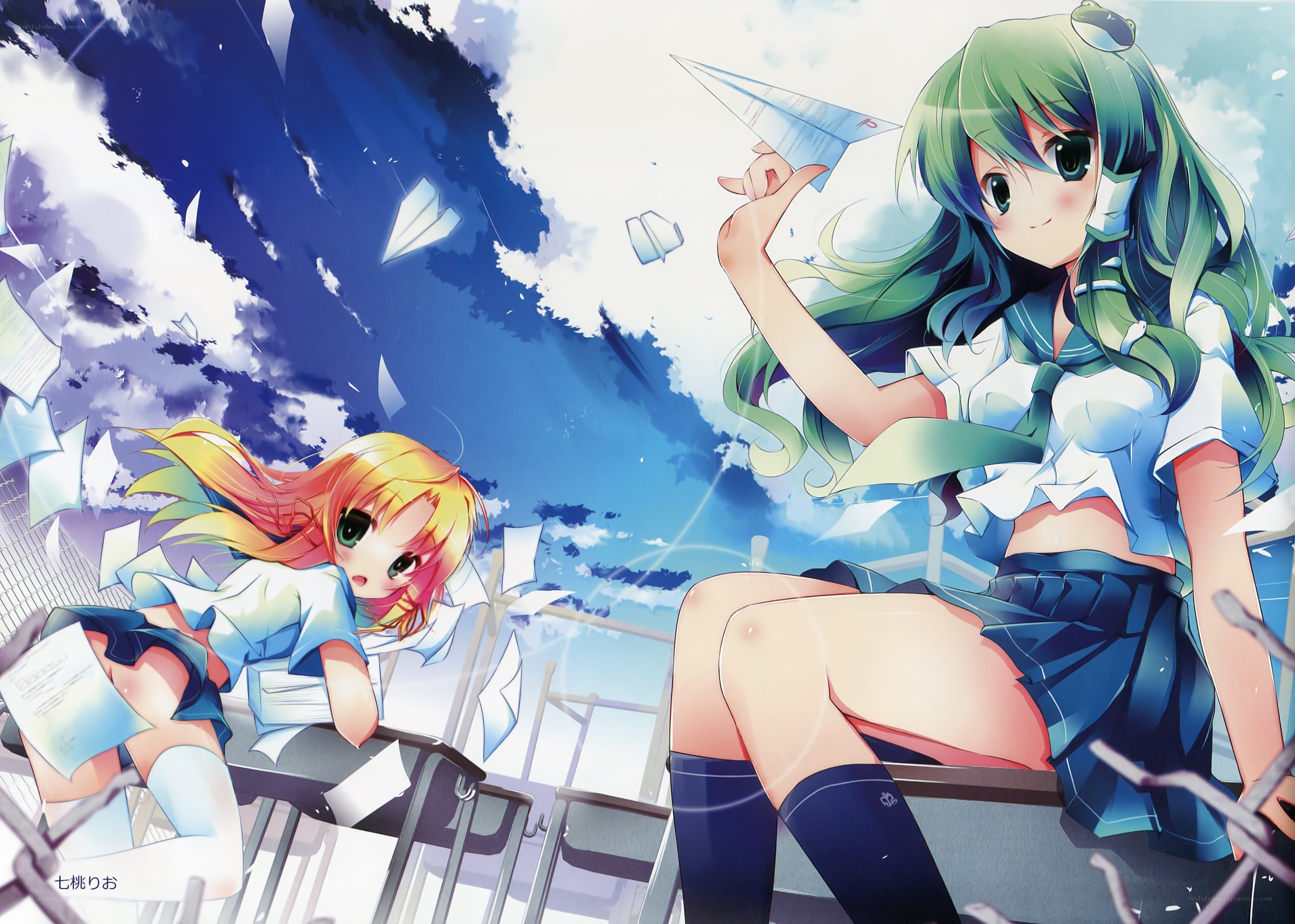 Two girls with paper airplanes