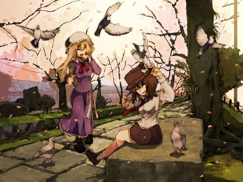 Two girls with pigeons in a park