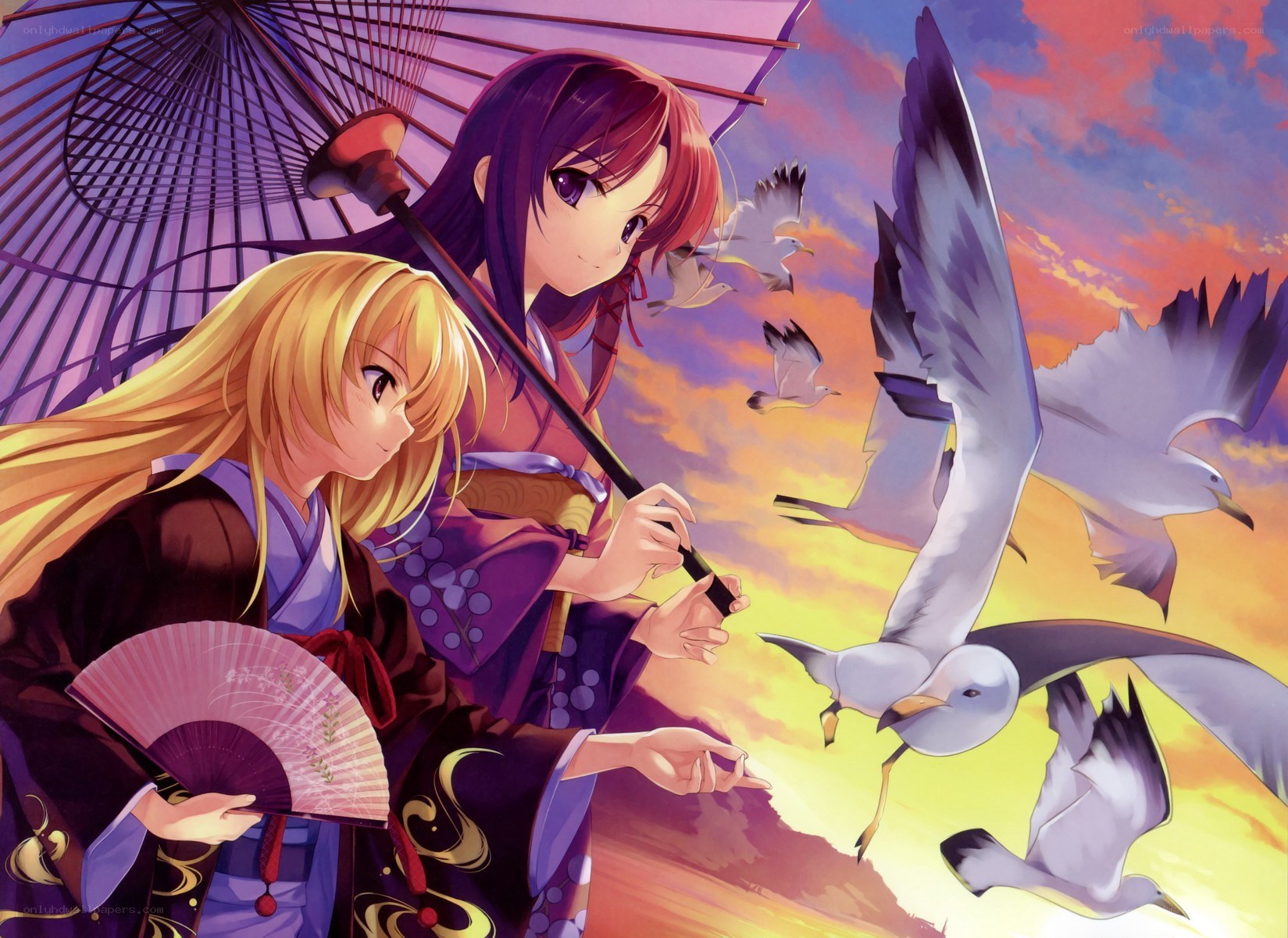 Two girls with seagulls at sunset