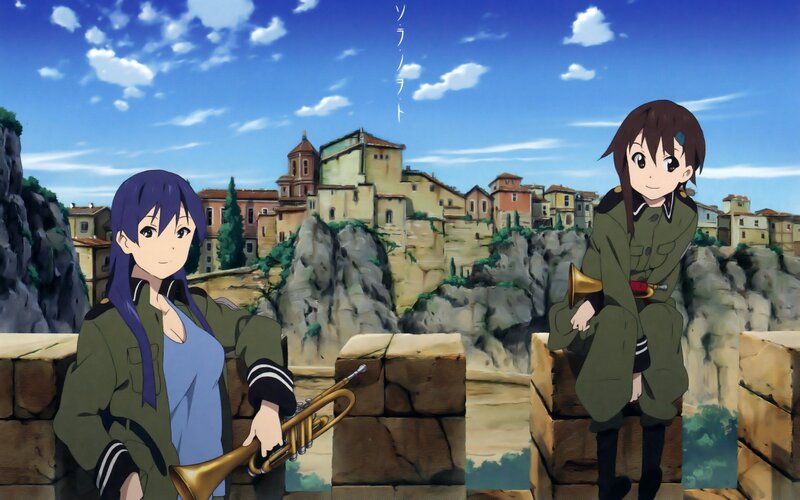 Two girls with trumpets on a cliff