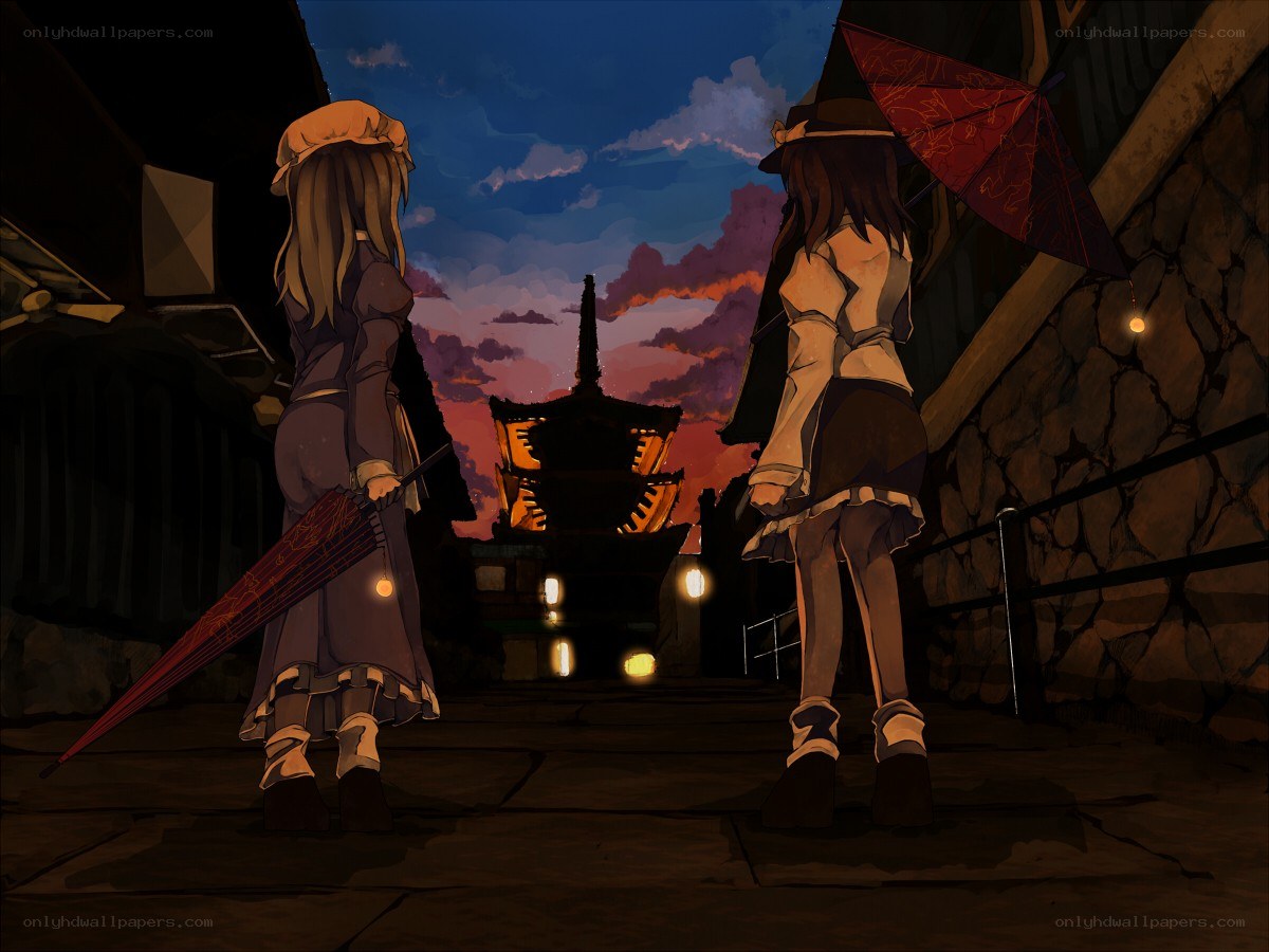 Two girls with umbrellas at dusk