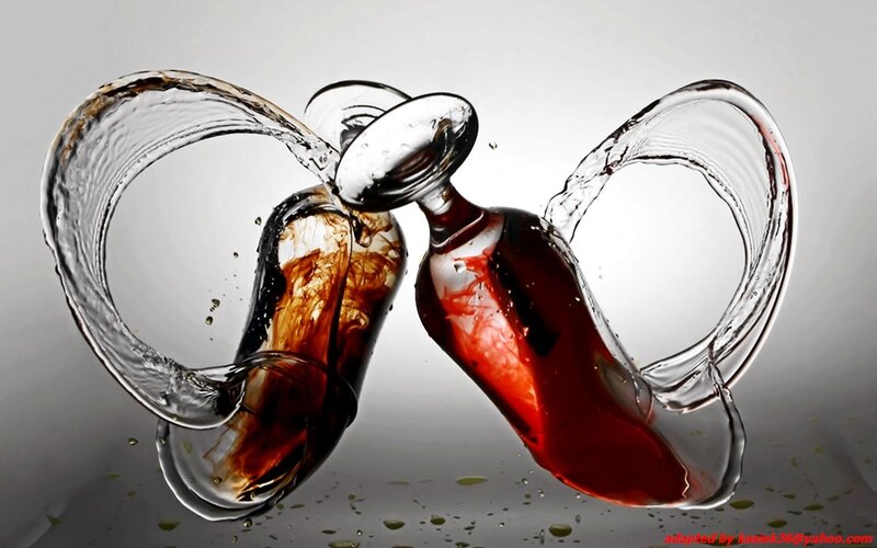 two glasses clinking with liquid splash
