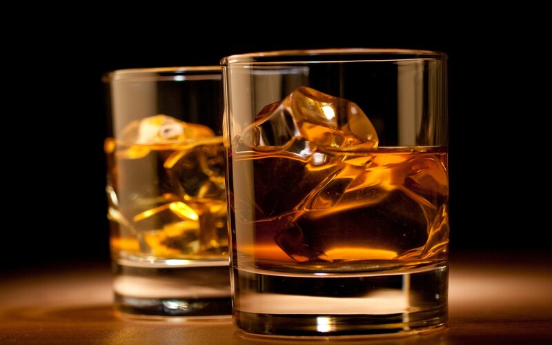 Two glasses of whiskey with ice