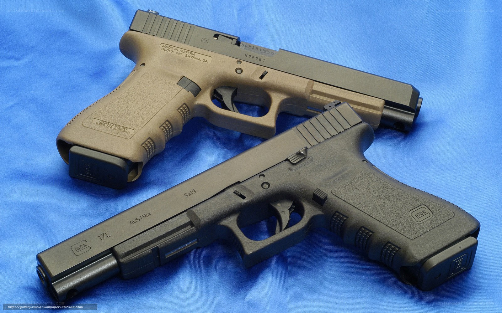 Two Glock pistols on blue cloth
