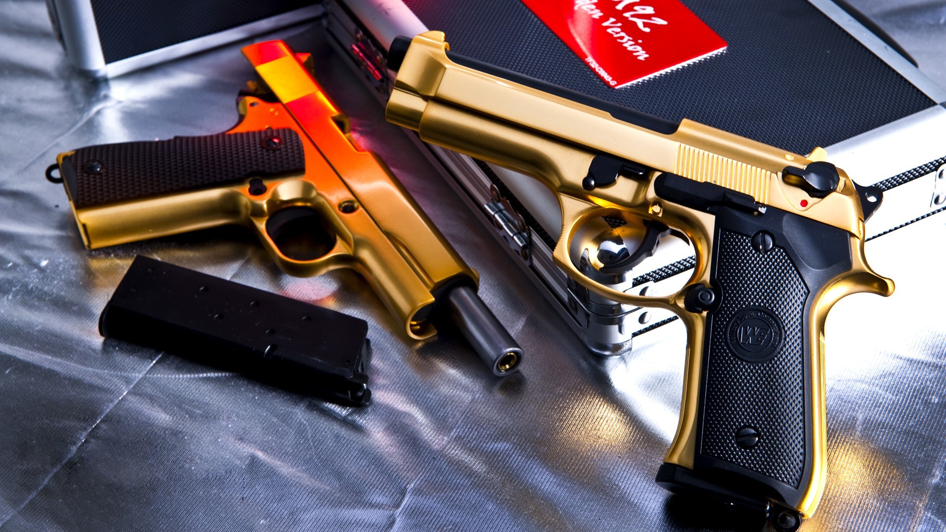 Two gold pistols on display