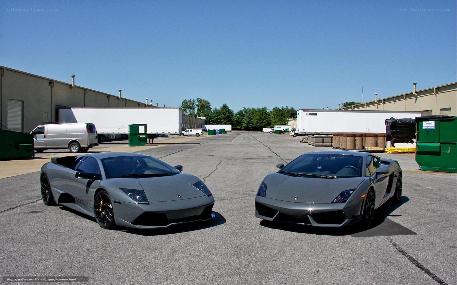 Two gray Lamborghinis in a lot