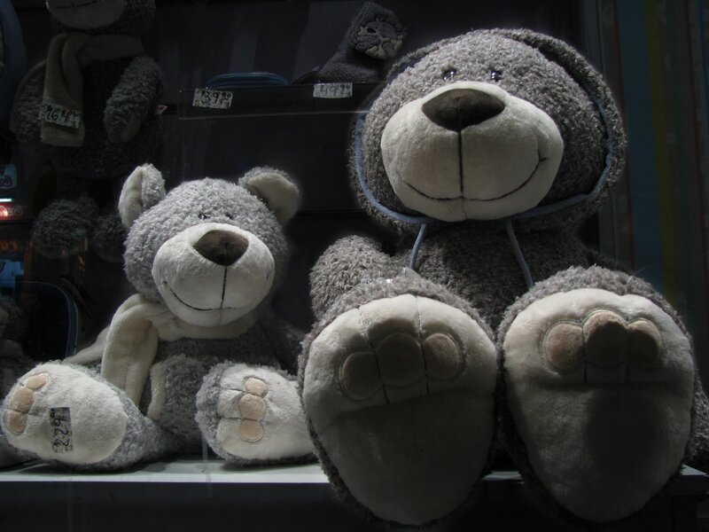 Two gray teddy bears in display