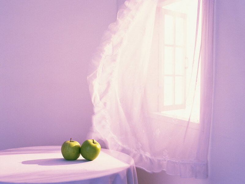 Two green apples on a table
