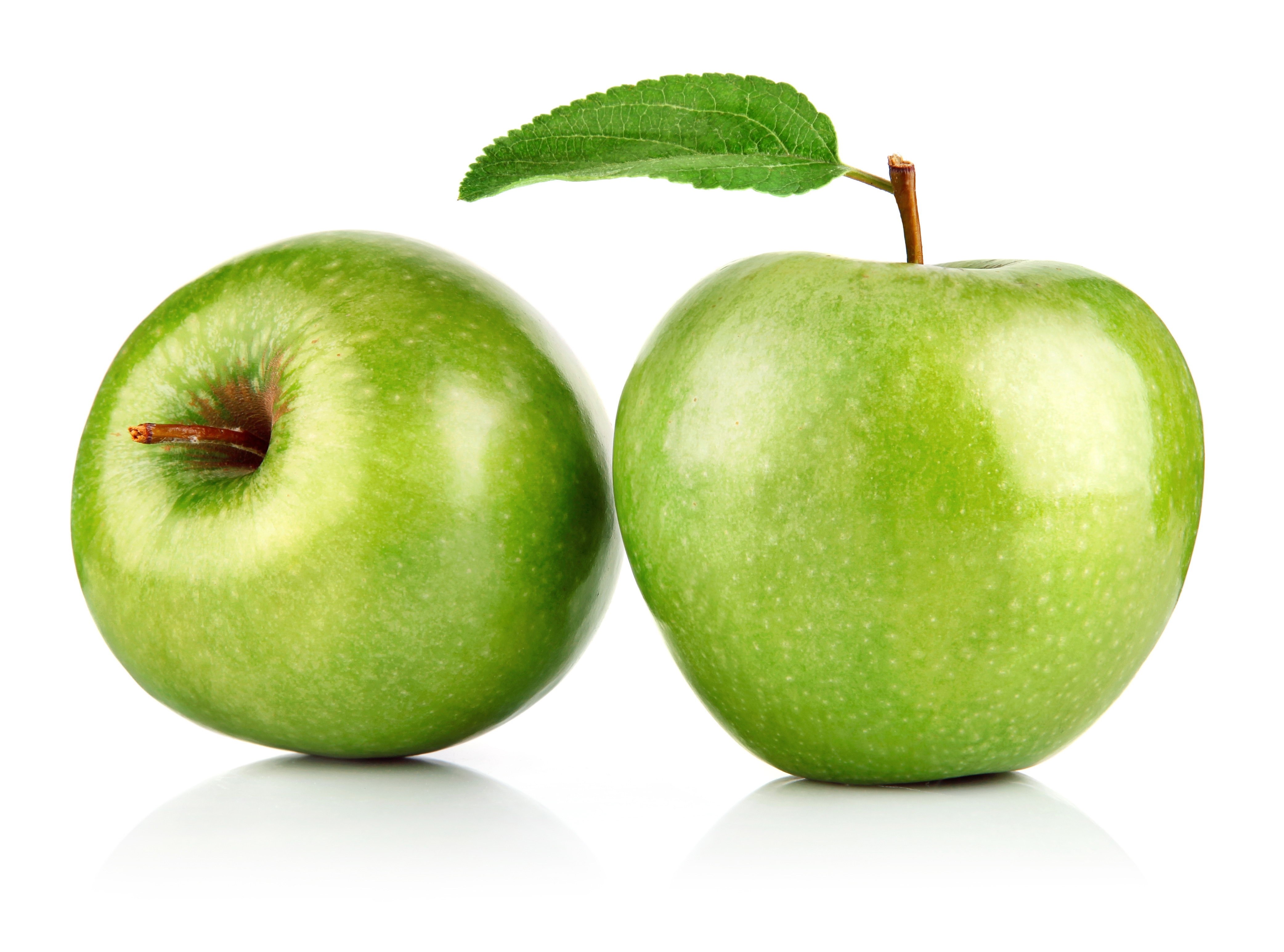 Two green apples with leaf