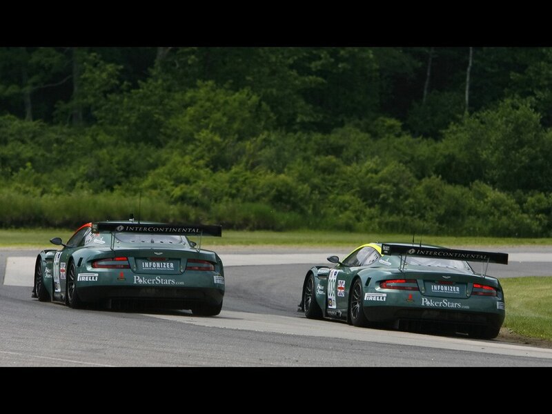 Two green race cars on a track