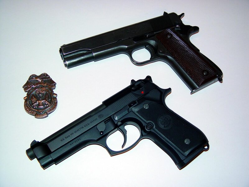 Two handguns and a badge