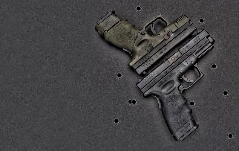 Two handguns on a target