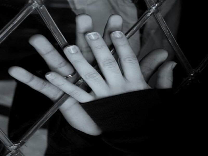 Two Hands Behind Glass